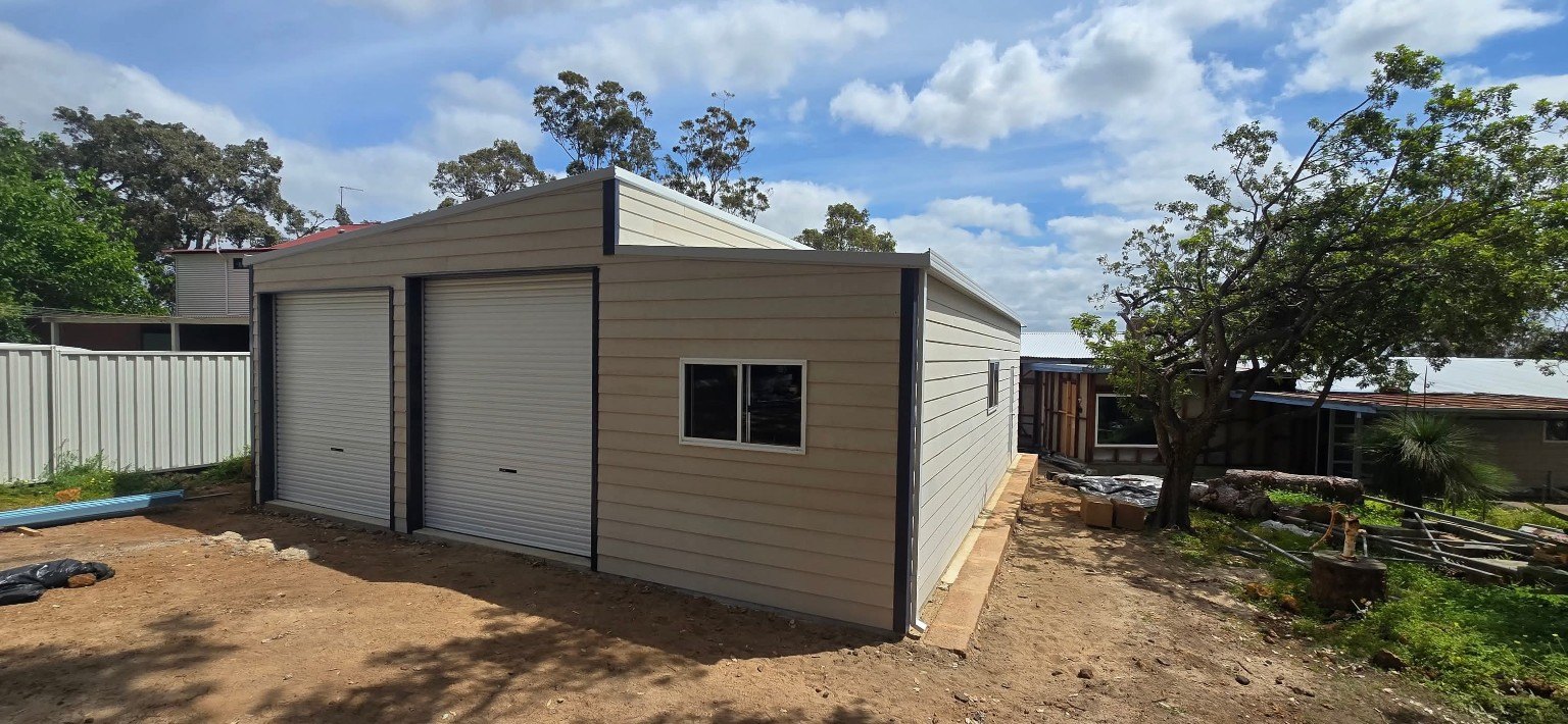 Light-clad shed with two roller doors and side window